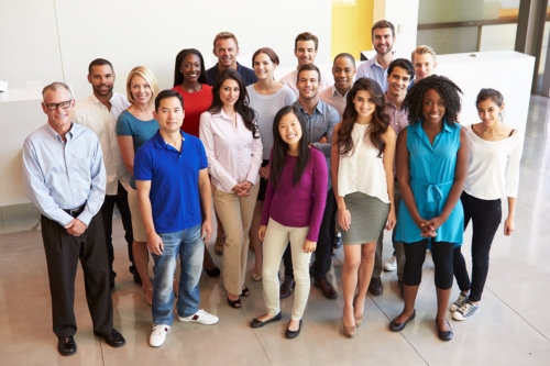 portrait of multi-cultural office staff standing in lobby